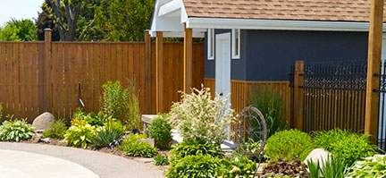Custom Wooden privacy fences by Niagara Hardscaping Services with Shed and metal fence
